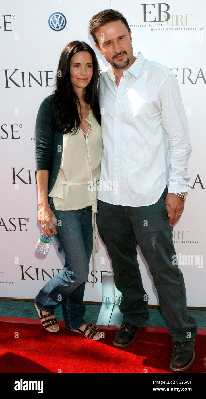 Hosts Courteney Cox, left, and her husband David Arquette pose at a