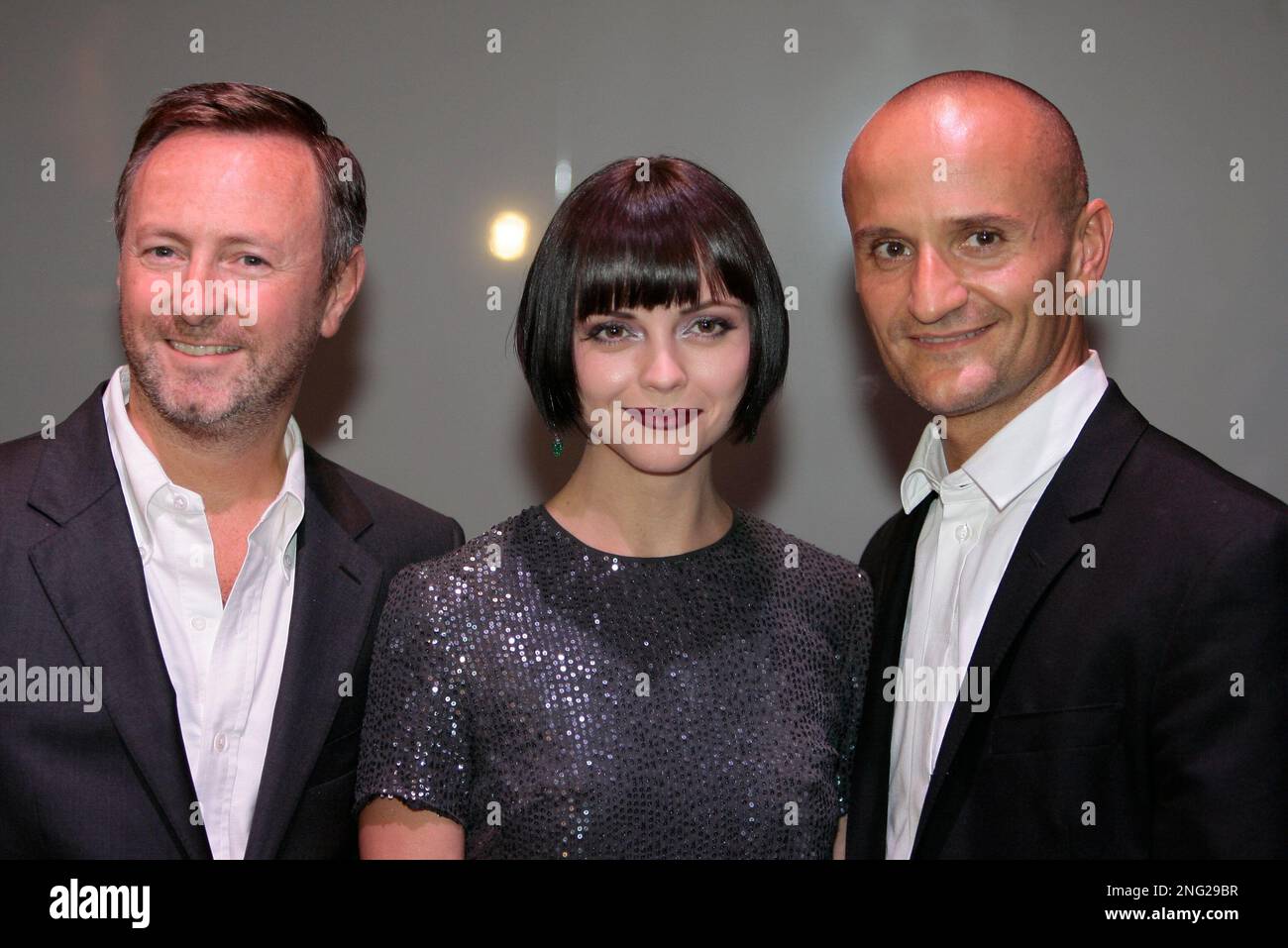 Actress Christina Ricci, center, poses with Kevin Carrigan, left, the  Creative director of ck Calvin Klein and Mark Carrasquillo, the Global  Make-up artist of ck Calvin Klein beauty, in Milan, Italy, Thursday,