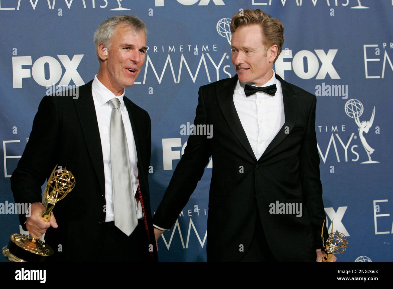 Head writer Mike Sweeney, left, and Conan O'Brien hold their