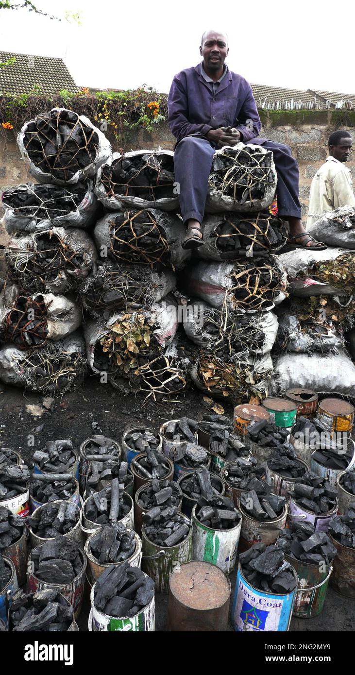 Paul Mwangi, 35, a roadside charcoal vendor sits on sack of charcoal