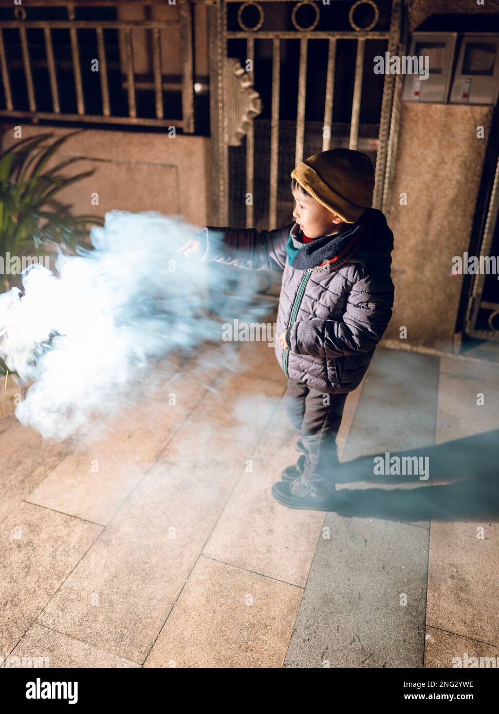 A young boy plays sparklers for the first time Stock Photo