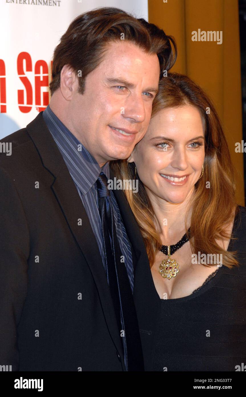 John Travolta, left, and his wife, Kelly Preston, arrive for the