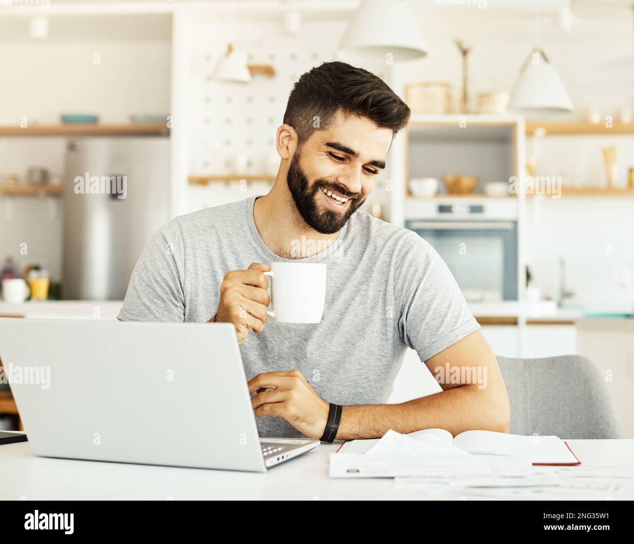 laptop man computer home technology young student business internet study document paperwork reading Stock Photo