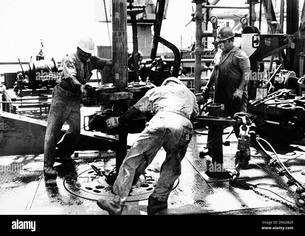 Workers aboard the Odessa, a jack-up offshore oil rig probing for oil ...