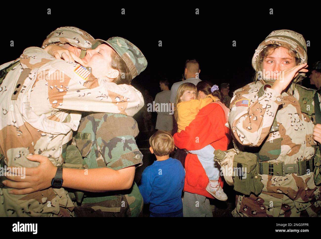 U.S. Army Pvt. Tabitha Miller, right, of Casper, Wyo., wiper away tears ...