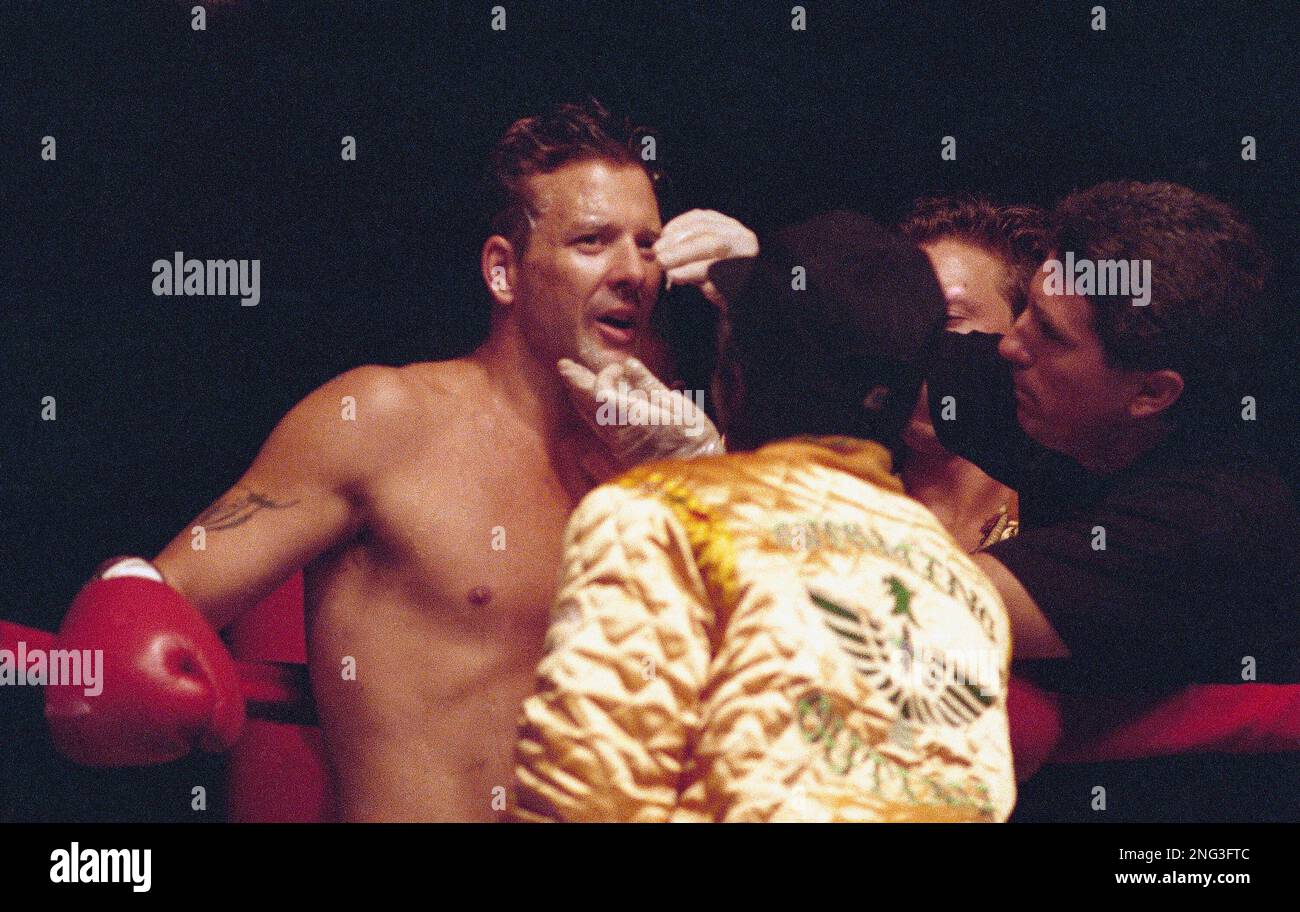 Trainers attend to actor Mickey Rourke's face during his professional ...