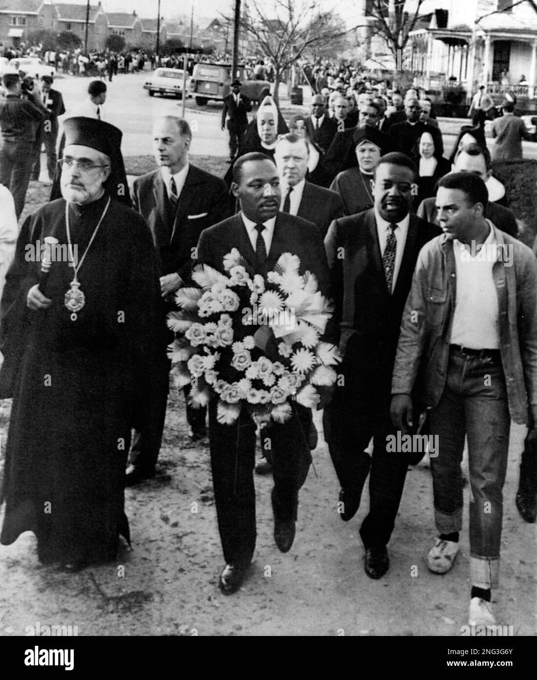 Civil rights leader Dr. Martin Luther King Jr. carries a wreath, March ...