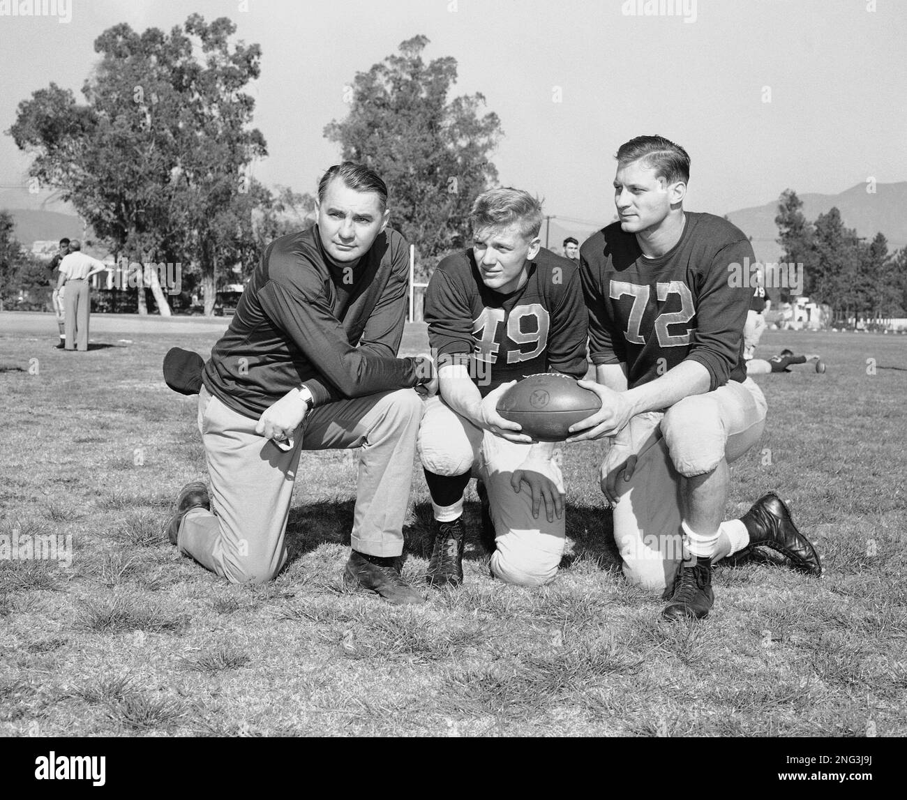 Coach Bennie Oosterbaan (left) of the University of Michigan football team gets together with his star halfback, Chuck Ortmann (center), and Capt. Al Wahl in Pasadena, Calif., Dec. 20, 1950 to cook