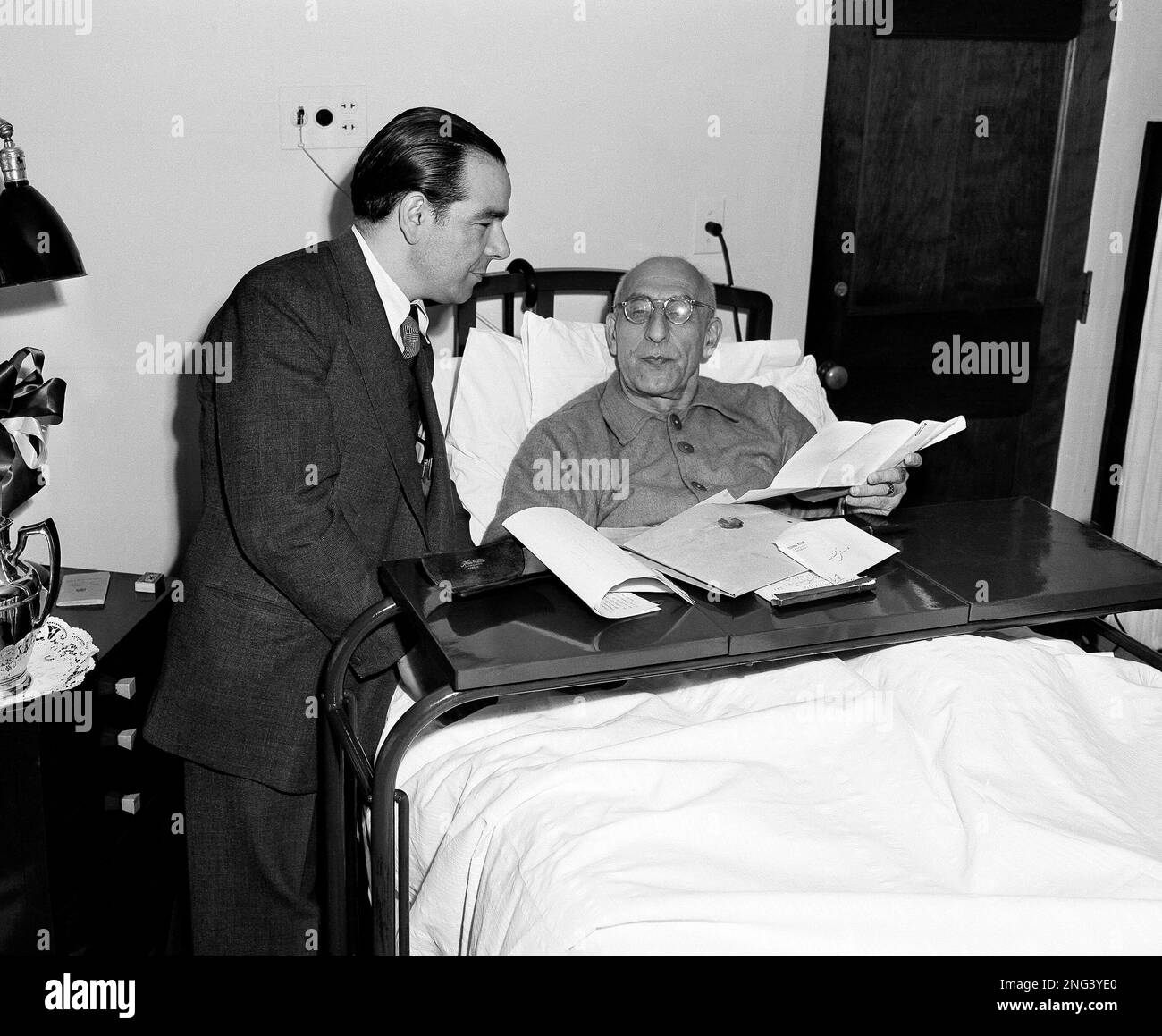 Deputy Premier Dr. Hossein Fatemi stands next to the bedside of Premier Mohammed Mossadegh of Iran on Oct. 12, 1951. Mossadegh was named Iran's prime minister on April 28, 1951. (AP Photo Stock Photo - Alamy