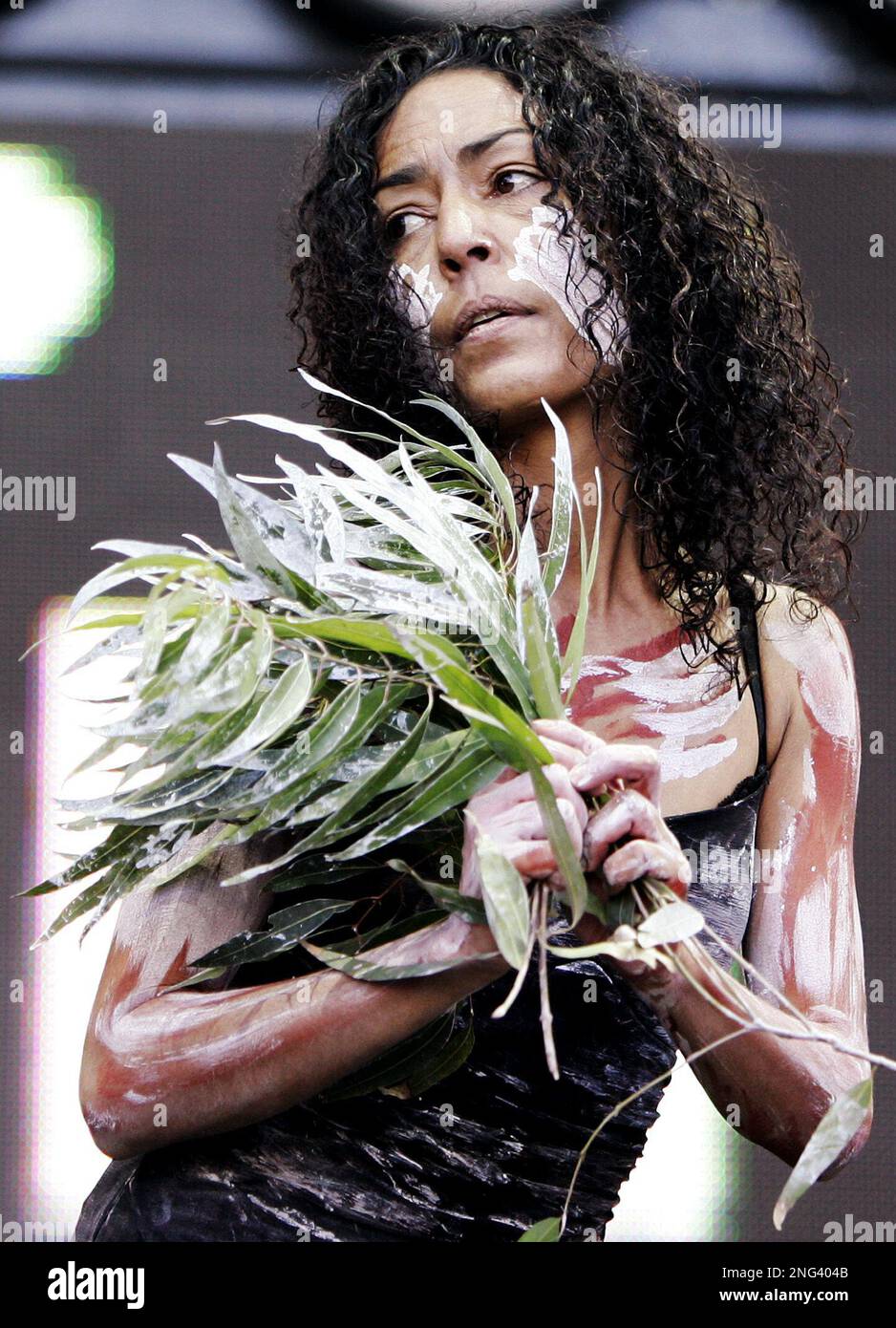 An Australian Aboriginal dances on stage during the opening of the ...