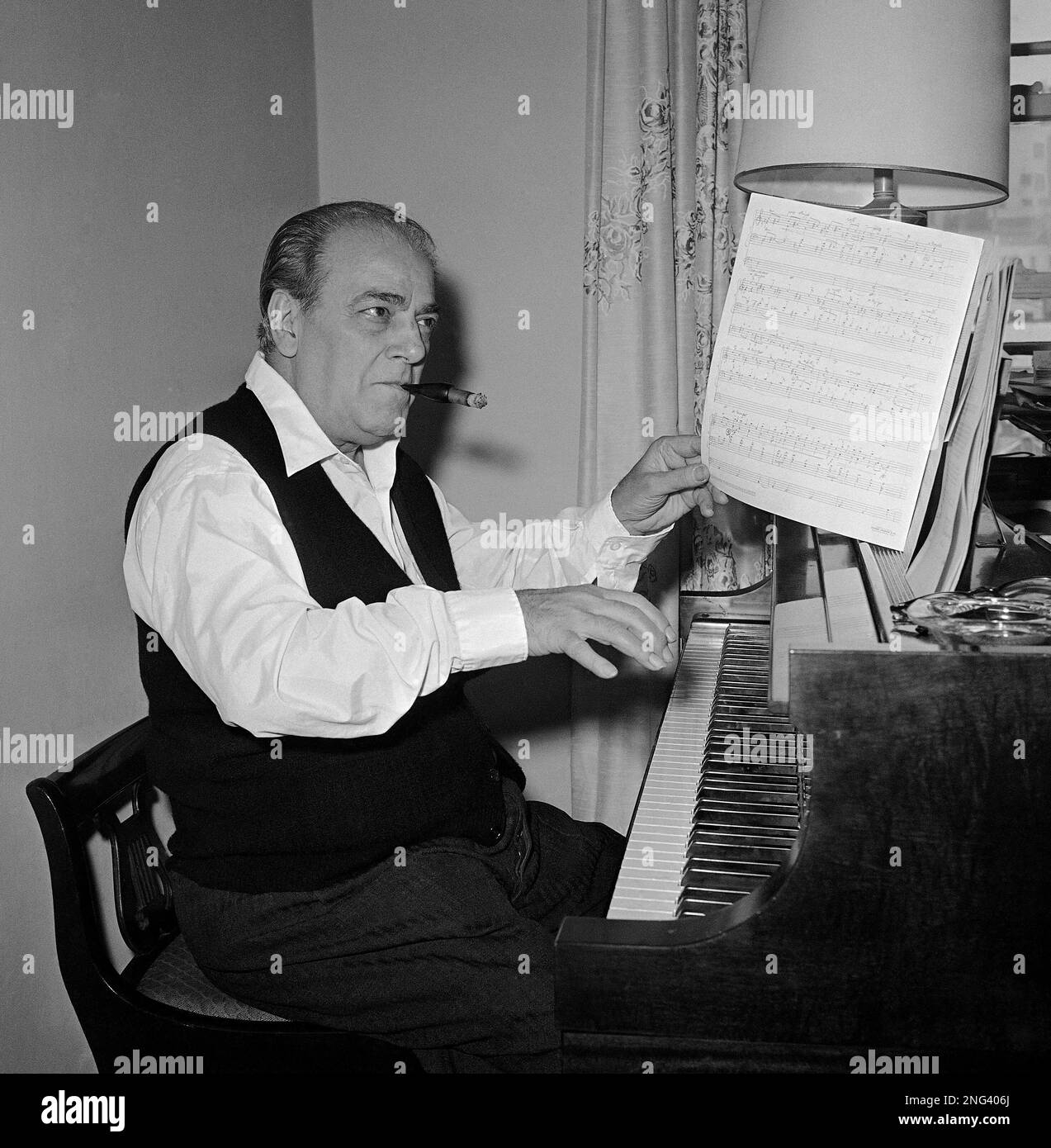 Brazilian composer-conductor Heitor Villa-Lobos, turns page as he ...
