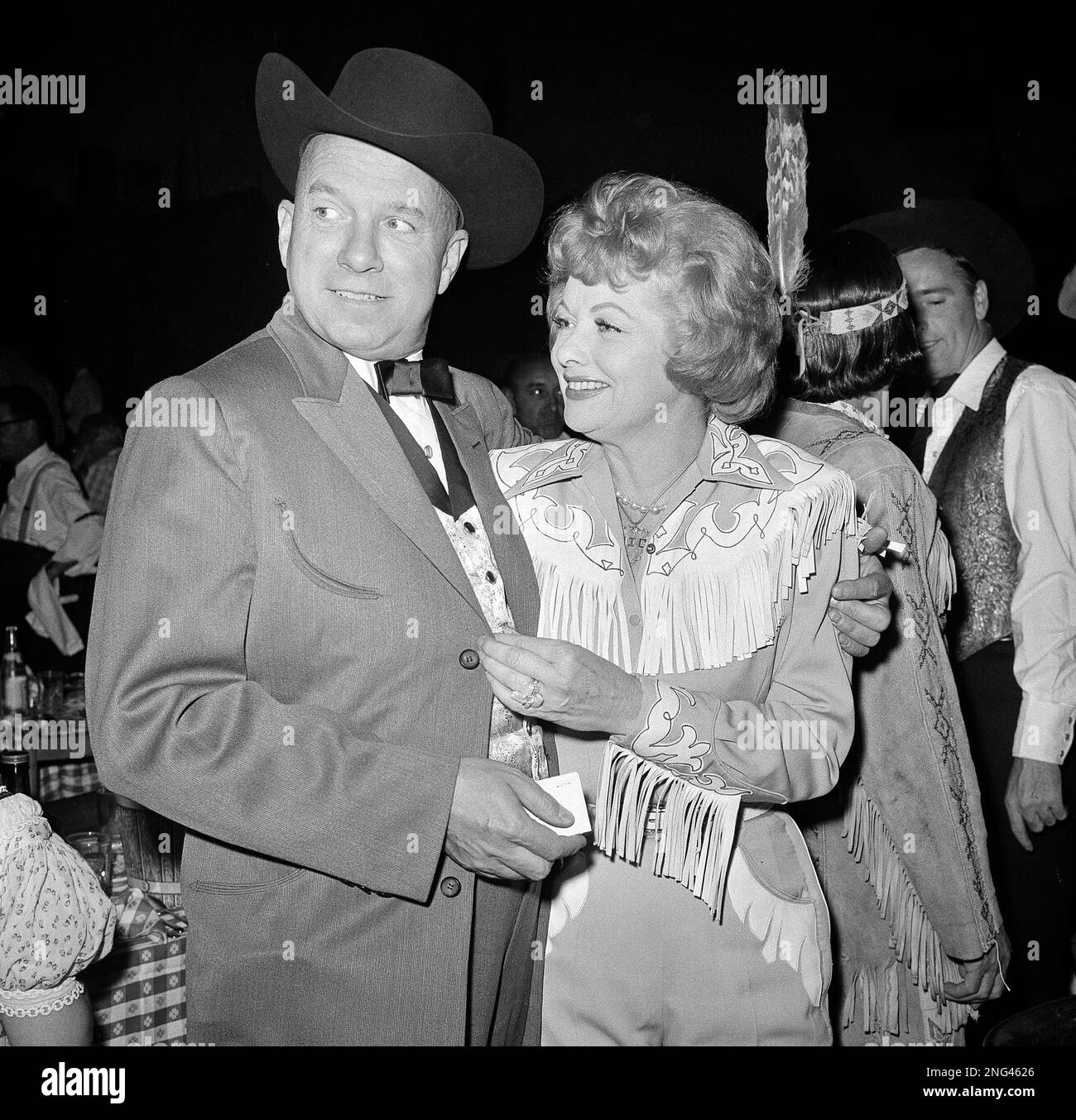 Lucille Ball, who recently divorced Desi Arnaz, attends the annual SHARE  charity party withn composer Jimmy Van Heusen in Hollwood, Calif. on May  13, 1960. The organization is composed of wives of