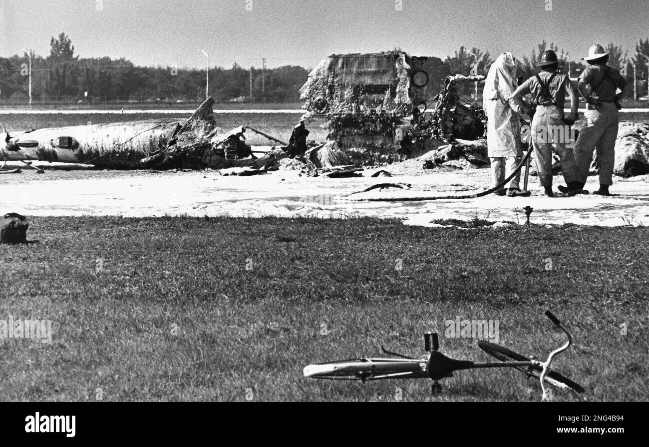 Fireman stand by the burned wreckage of a collision between a U.S