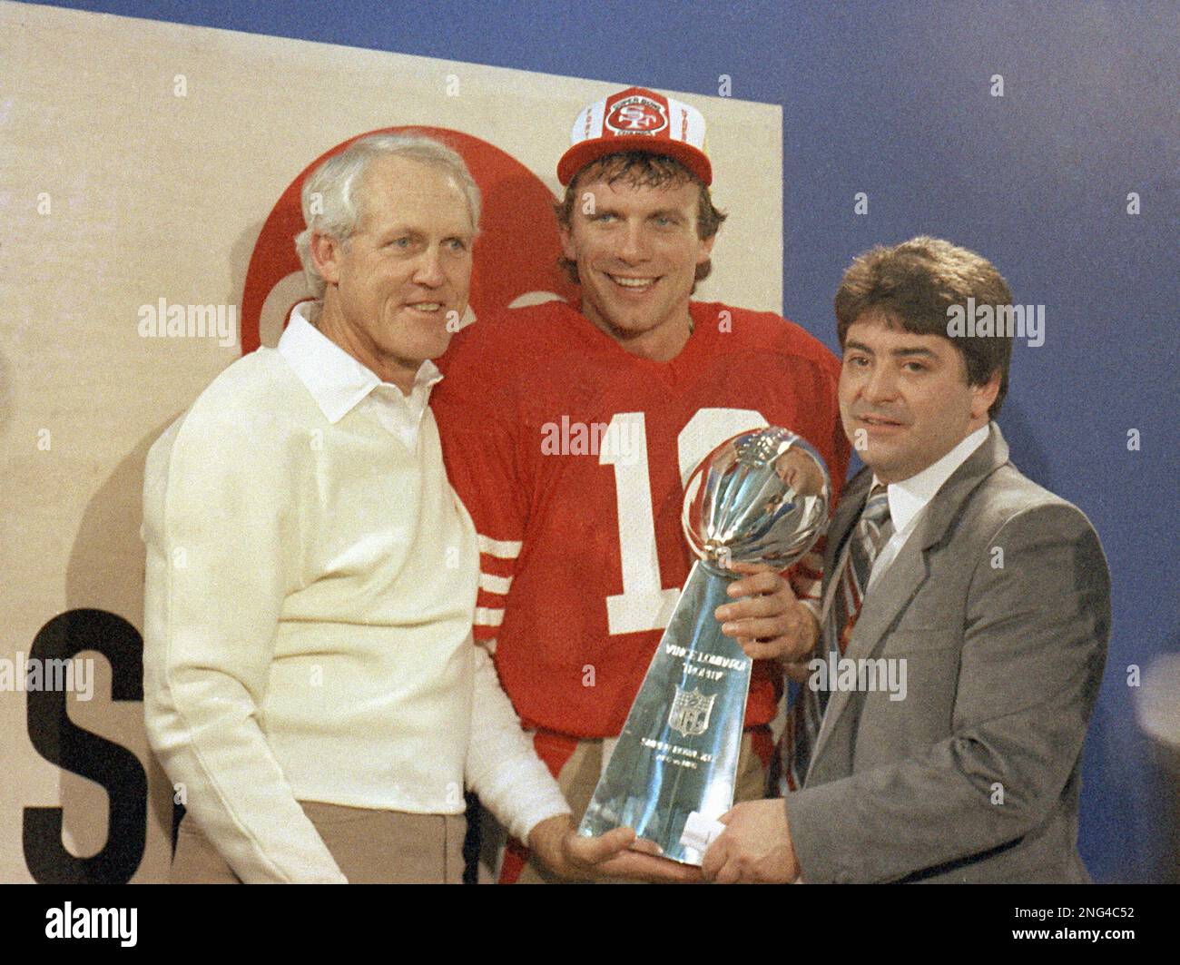 San Francisco 49ers' quarterback Joe Montana, center, is shown holding ...