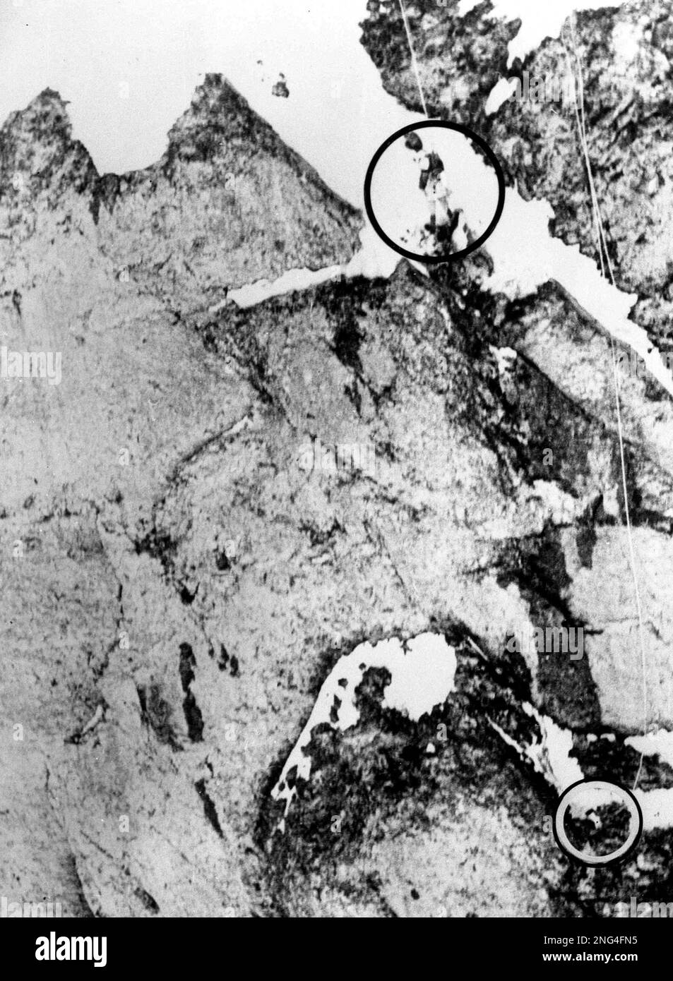 Roped to the rock face of the North wall of the Eiger Mountain in the