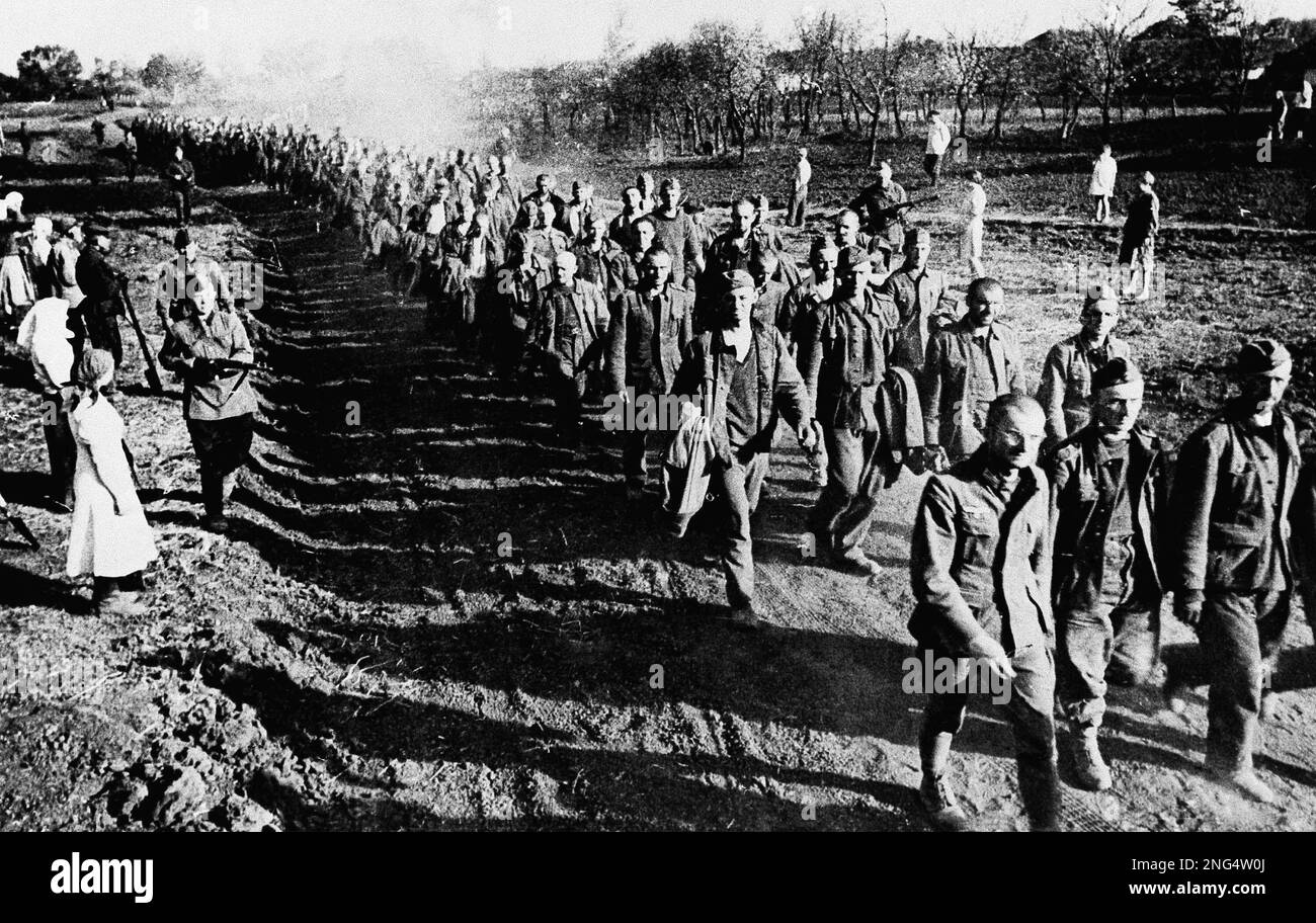 A long line of German soldiers marching into captivity escorted by ...