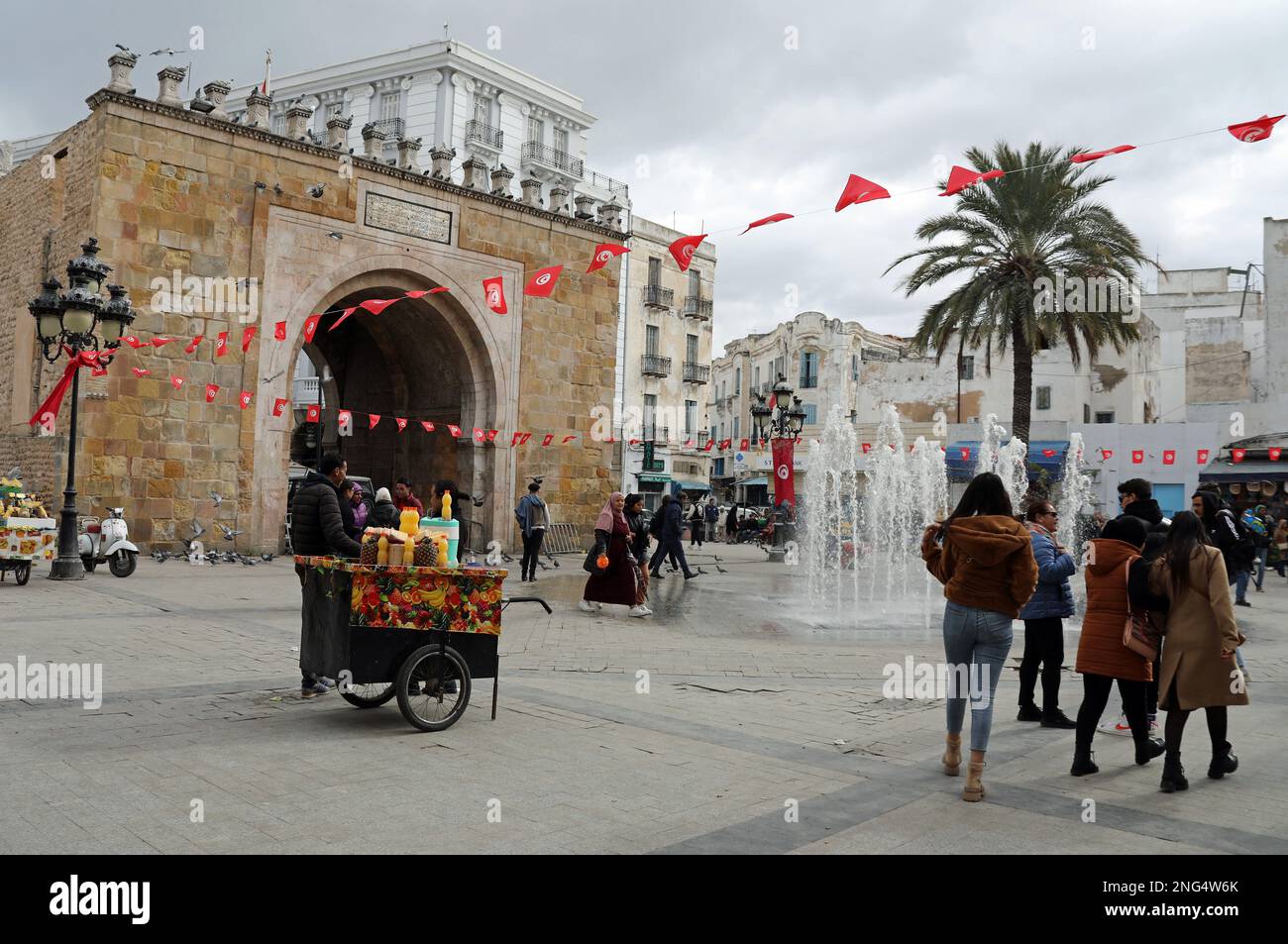 Tourists by the arched City Gate in Tunis Stock Photo