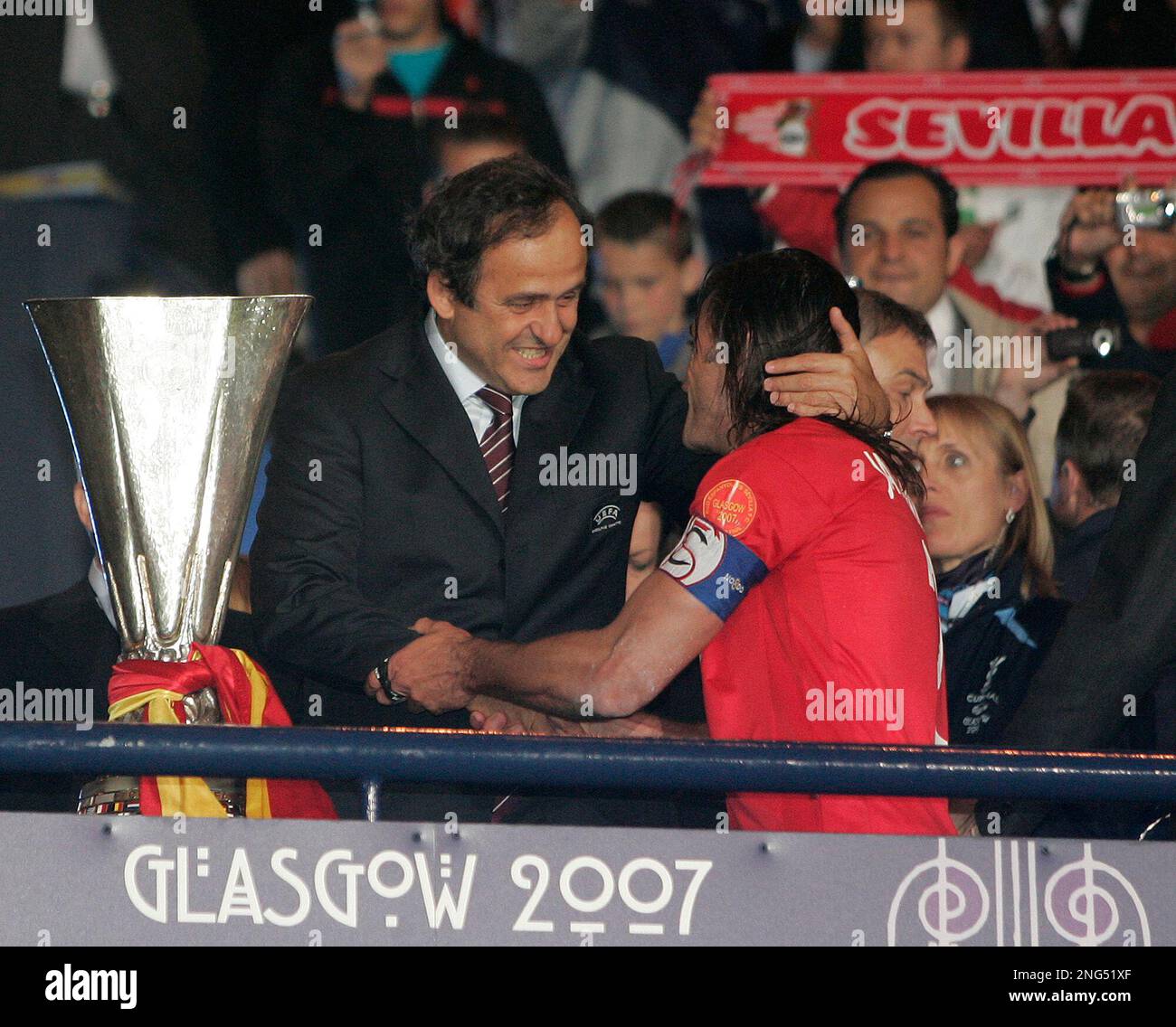 Sevilla's captain Javi Navarro, right, is greeted by UEFA President