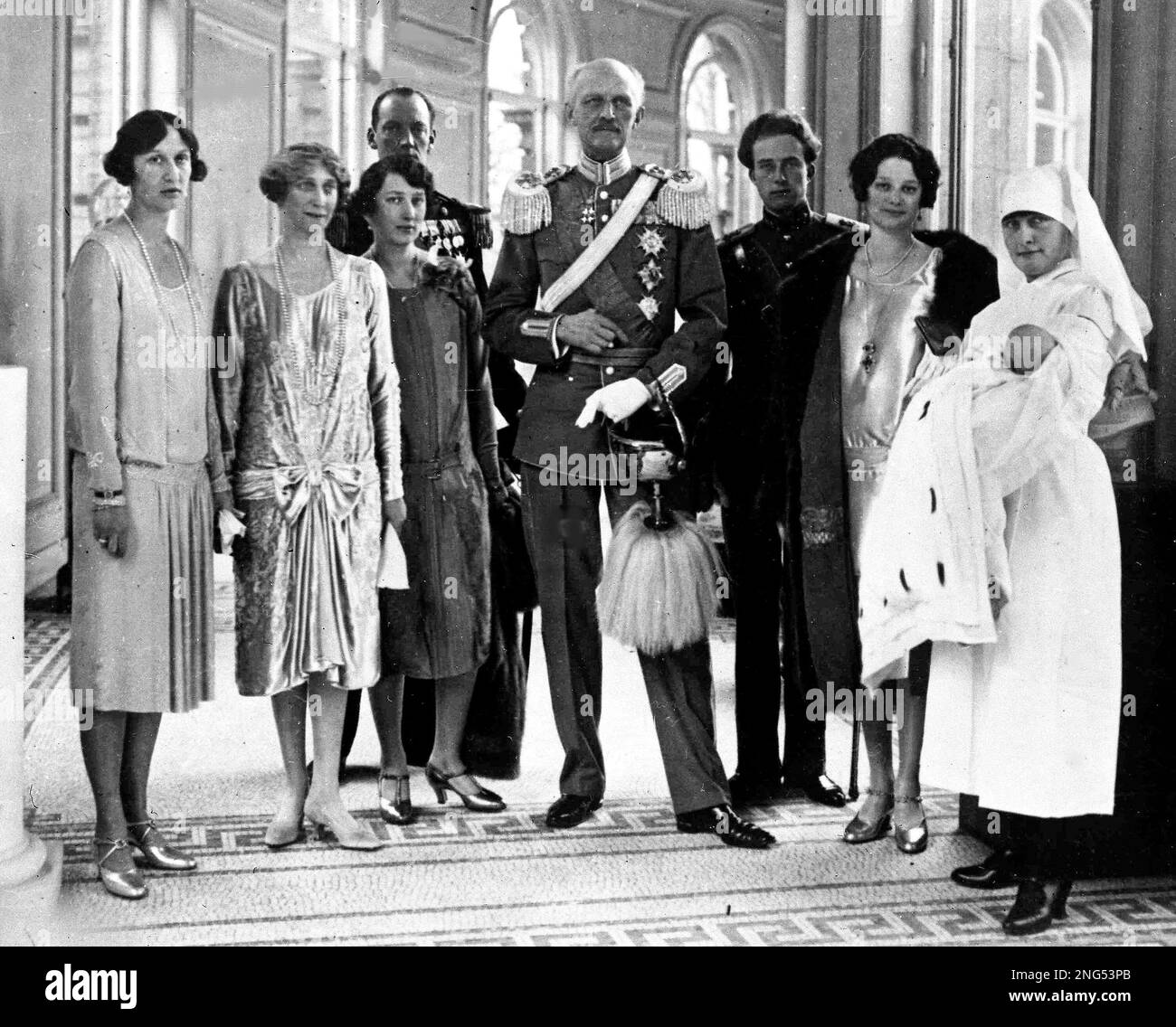 Members of the Belgium royal family pose for photographers as they present Princess Josephine-Charlotte to the public, right in arms of nurse, in the Royal Palace, in Brussels, Oct. 13, 1927. From right to left; Nurse with Princess Josephine-Charlotte,; Princess Astrid, her mother; Prince Leopold, her father; King Albert I; and Queen Elizabeth, second from left. Others in picture unidentified. (AP Photo) Stock Photo