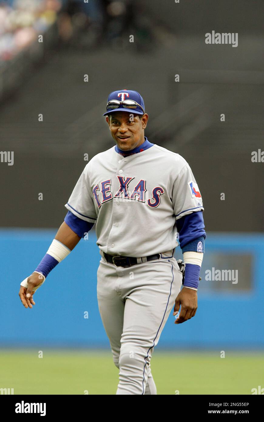 Texas Rangers' Sammy Sosa smiles as he walks to the field to report for his  first day of spring training workouts with the team in Surprise, Ariz.,  Friday, Feb. 23, 2007. (AP