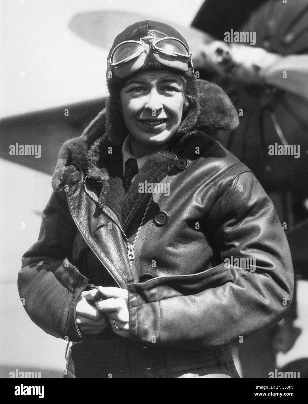 Miss Elinor Smith beside her plane before marking an assault on the women's  altitude record at Roosevelt Field, Long Island, March 27, 1931. She was  forced to come down after reaching about