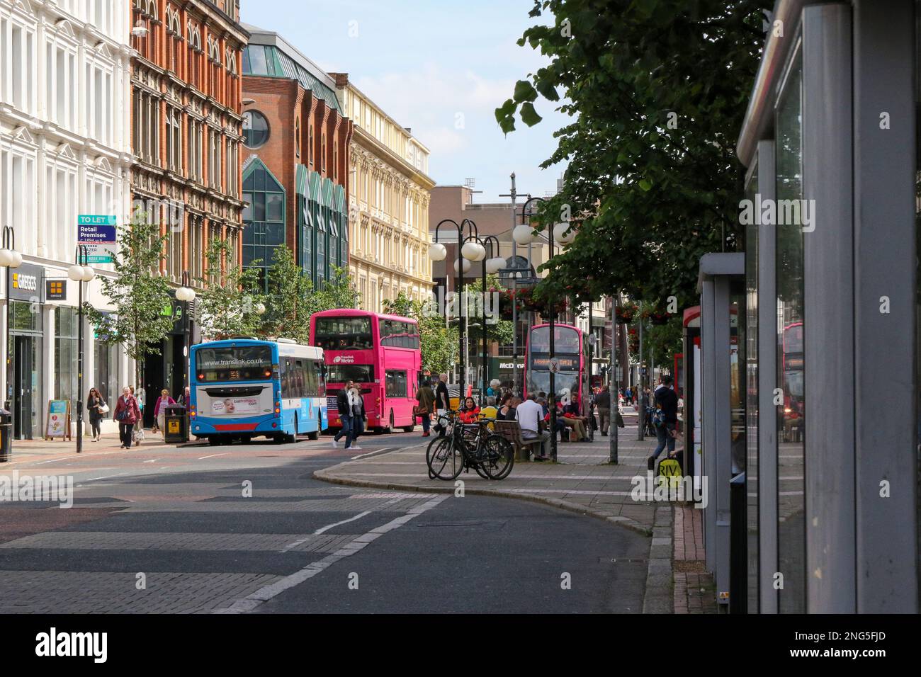 Commercial shops businesses Belfast city centre with pedestrians and