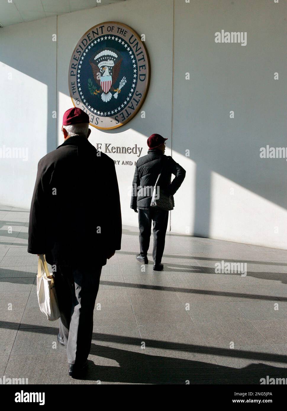 Visitors walk through the lobby of the John F. Kennedy Library in ...