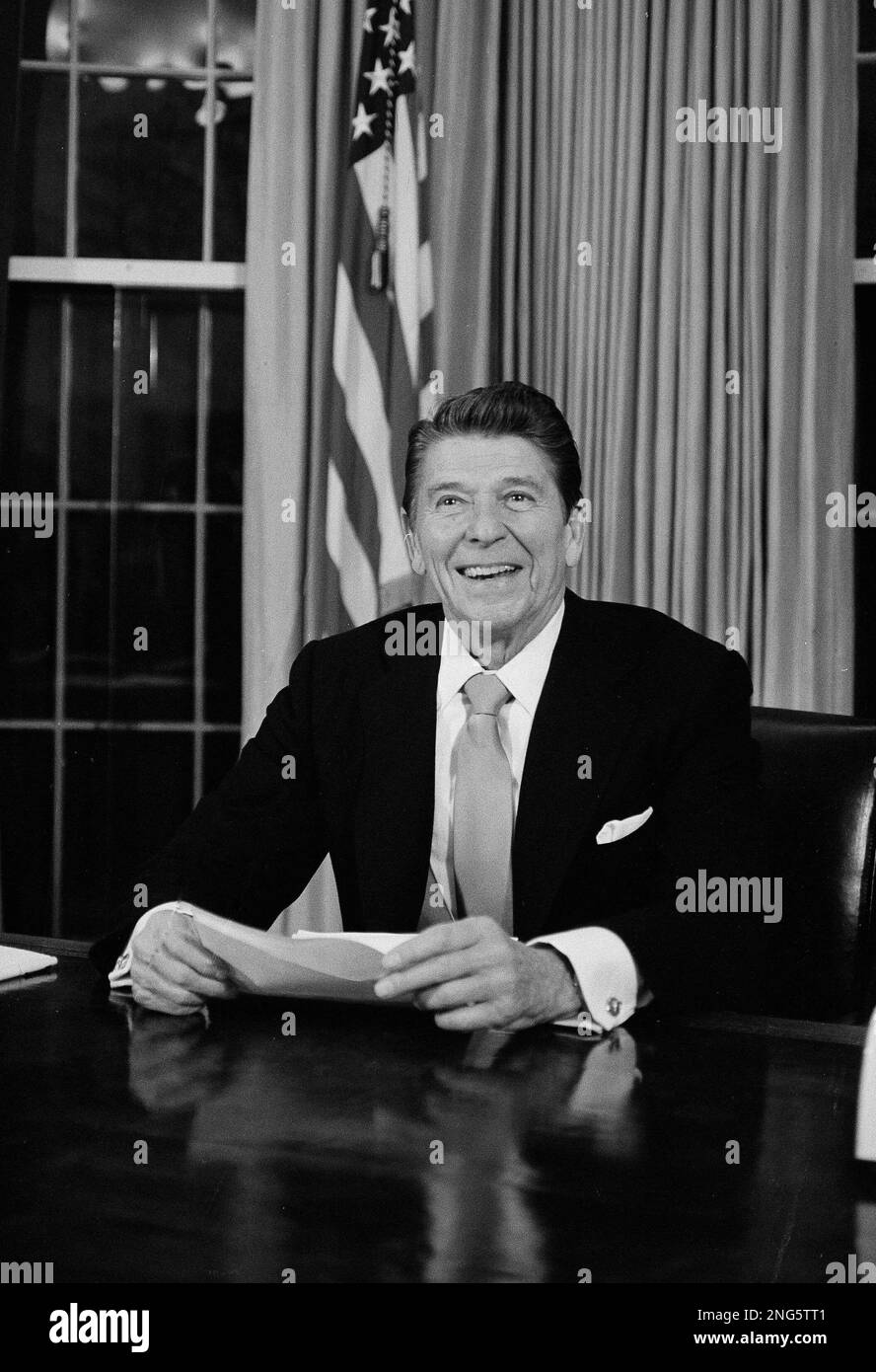 President Ronald Reagan tries out his new desk in the Oval Office in ...