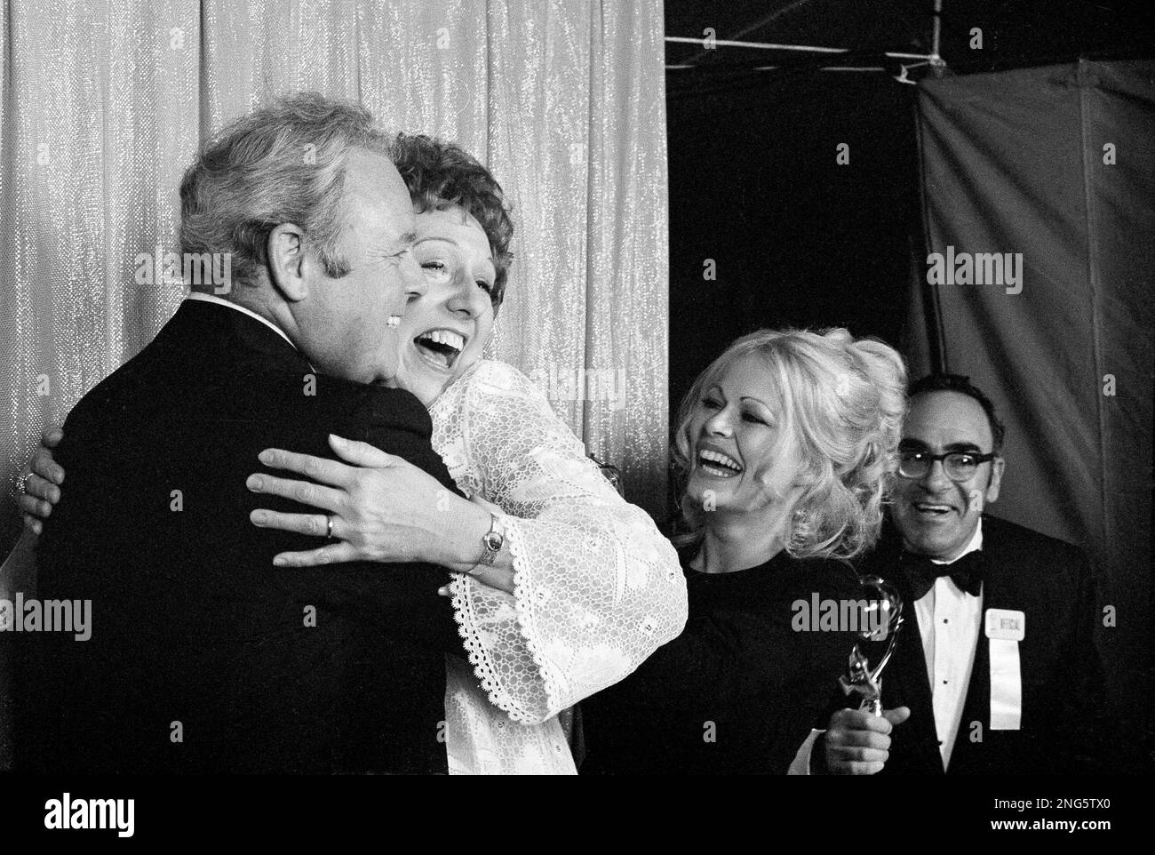 Carroll O'Connor, who plays the bigoted Archie Bunker on CBS-TV's "All In  The Family," gets a hug from co-star Jean Stapleton who plays his devoted  wife Edith, as Sally Struthers who plays