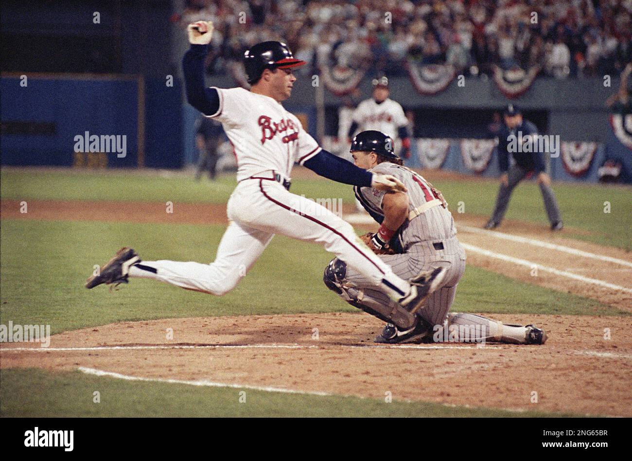 Atlanata Braves Mark Lemke slides home safely past Minnesota Twins catcher  Brian Harper to score the game-winning run in the 9th inning of Wednesday's  World Series game. In the early hours of