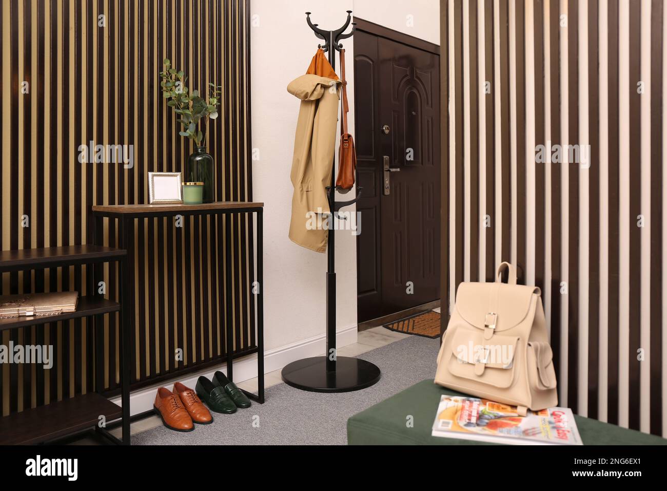 Modern hallway interior with console table and clothes rack Stock Photo ...