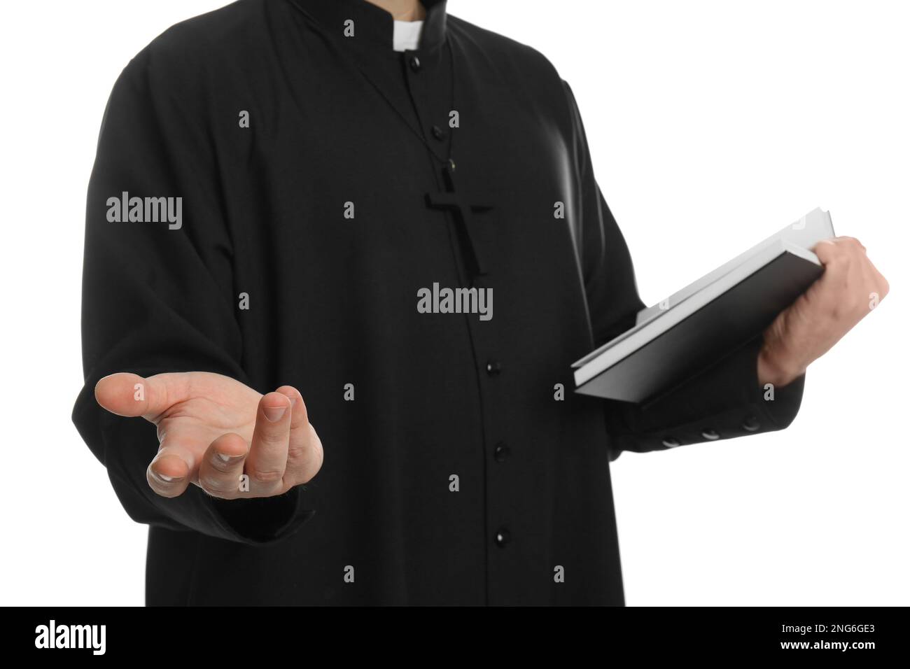 Priest with Bible praying on white background, closeup Stock Photo