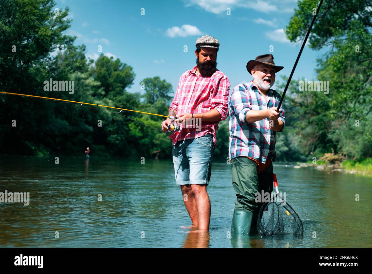 https://c8.alamy.com/comp/2NG6H6X/bearded-elegant-men-fisher-fishing-equipment-fishing-is-fun-man-relaxing-and-fishing-by-lakeside-pothunter-fly-fish-hobby-of-men-in-checkered-2NG6H6X.jpg