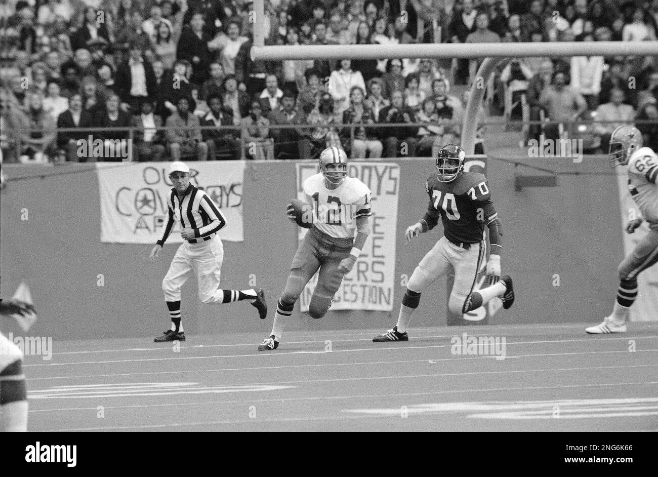 Roger Staubach, Dallas Cowboys' quarterback, scrambles his way to a first  down when all of his receivers were covered. Jim Marshall (70) Minnesota  Vikings' end, chases Staubach. Staubach covered 9 yards on