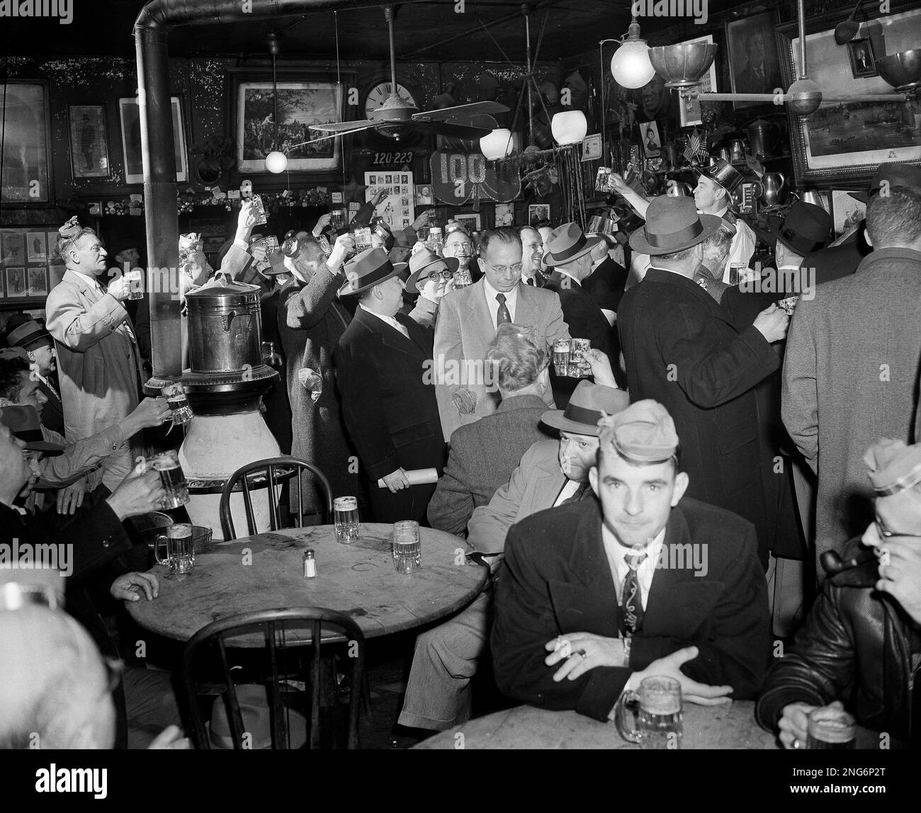 Regulars and tourists raise mugs of ale to toast a century of good food and  grog and no women at McSorley's Old Ale House, a landmark bar in the Lower  East Side, image size:1300x1148