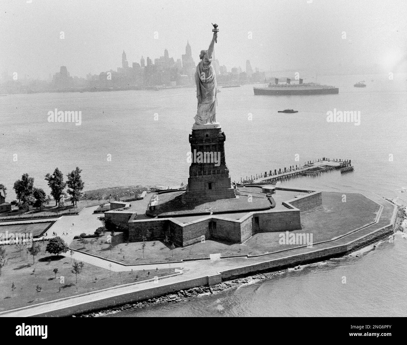 The Statue of Liberty stands in New York Harbor as the ocean liner