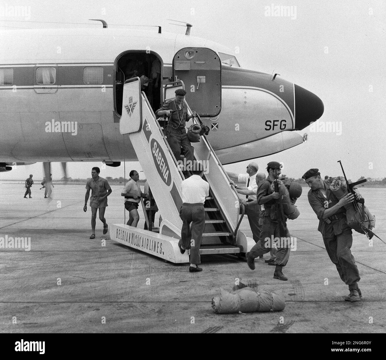 Belgian paratroopers rush from a Boeing aircraft on landing at