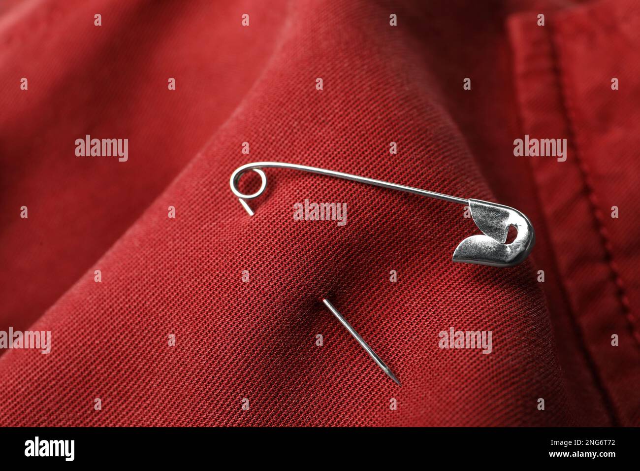 Closeup view of metal safety pin on clothing Stock Photo Alamy