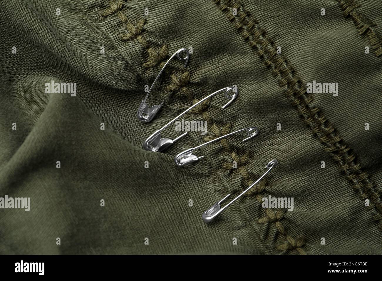 Top view of metal safety pins on clothing Stock Photo Alamy