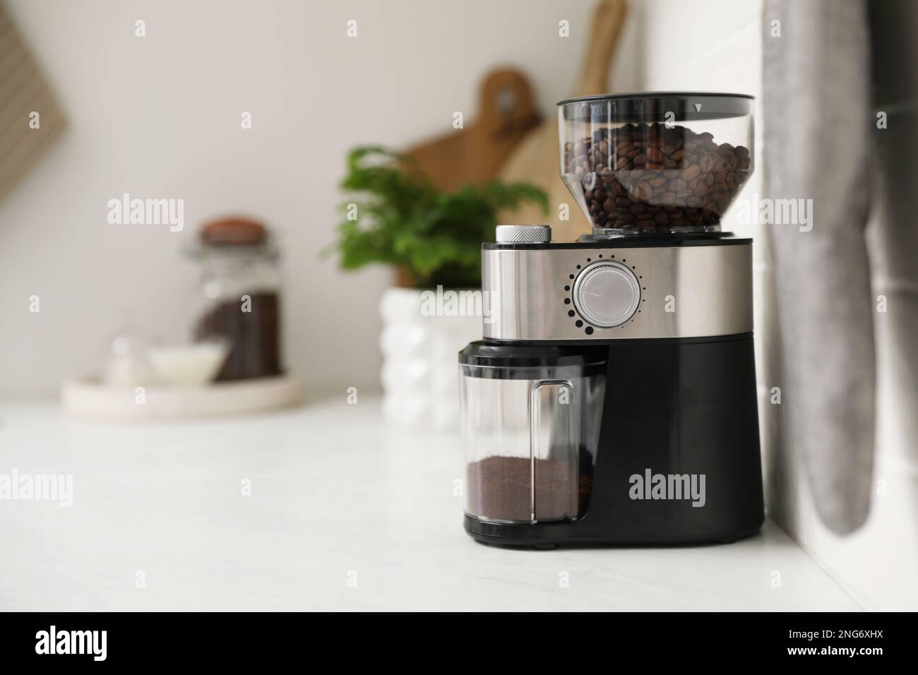 Modern coffee grinder on counter in kitchen Stock Photo Alamy