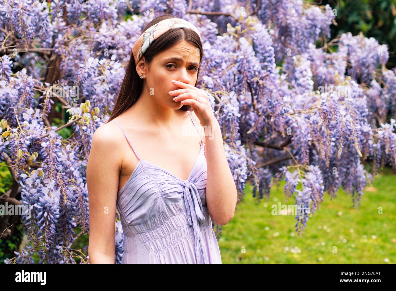 Girl with nose sneezing. Polen allergy symptom concept. Woman being ...