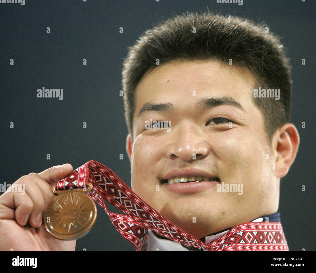 Japan's Hiroaki Doi smiles after receiving the bronze medal in the