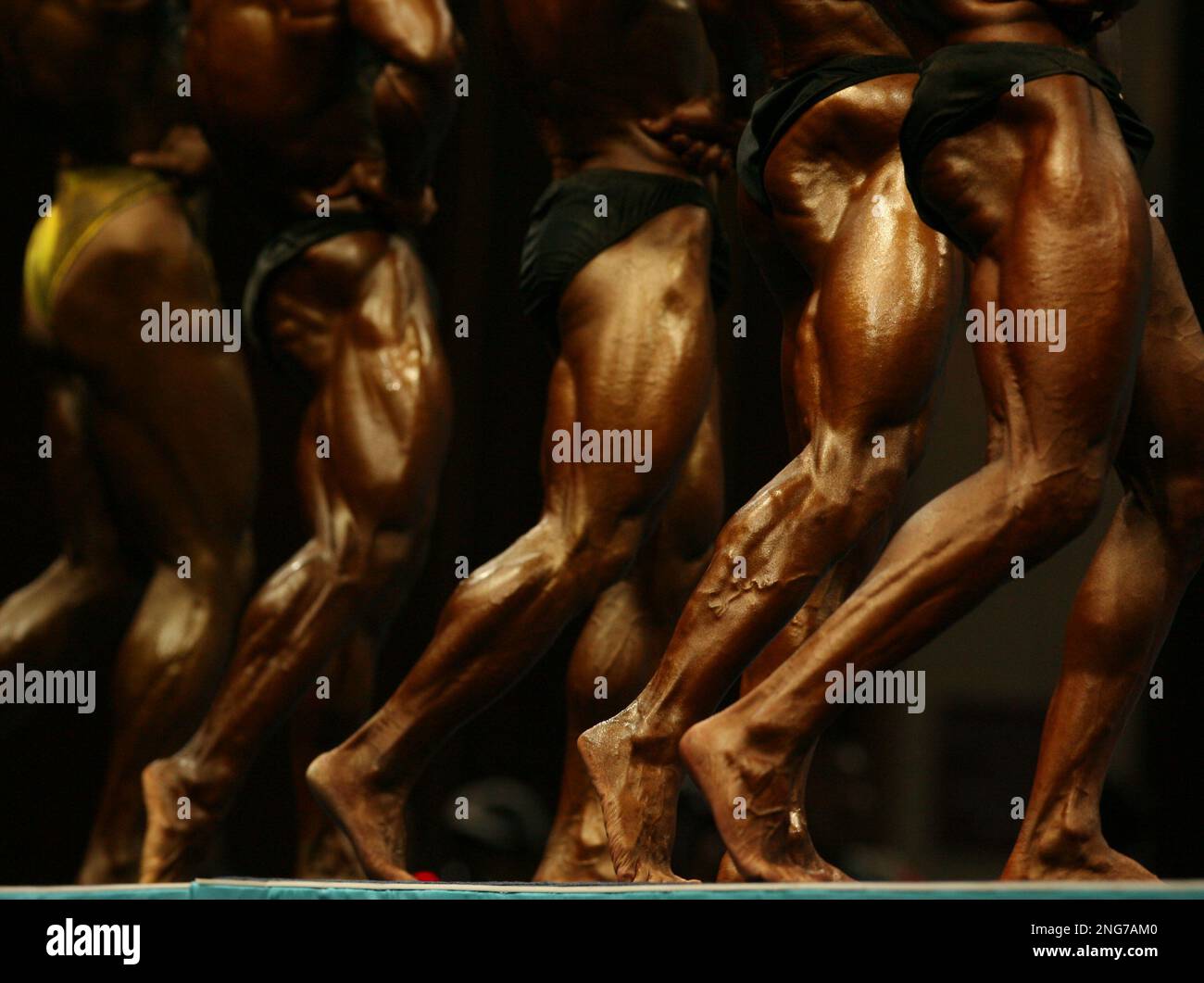 Competitors in the Asian Games Bodybuilding Men's 60kg final pose in
