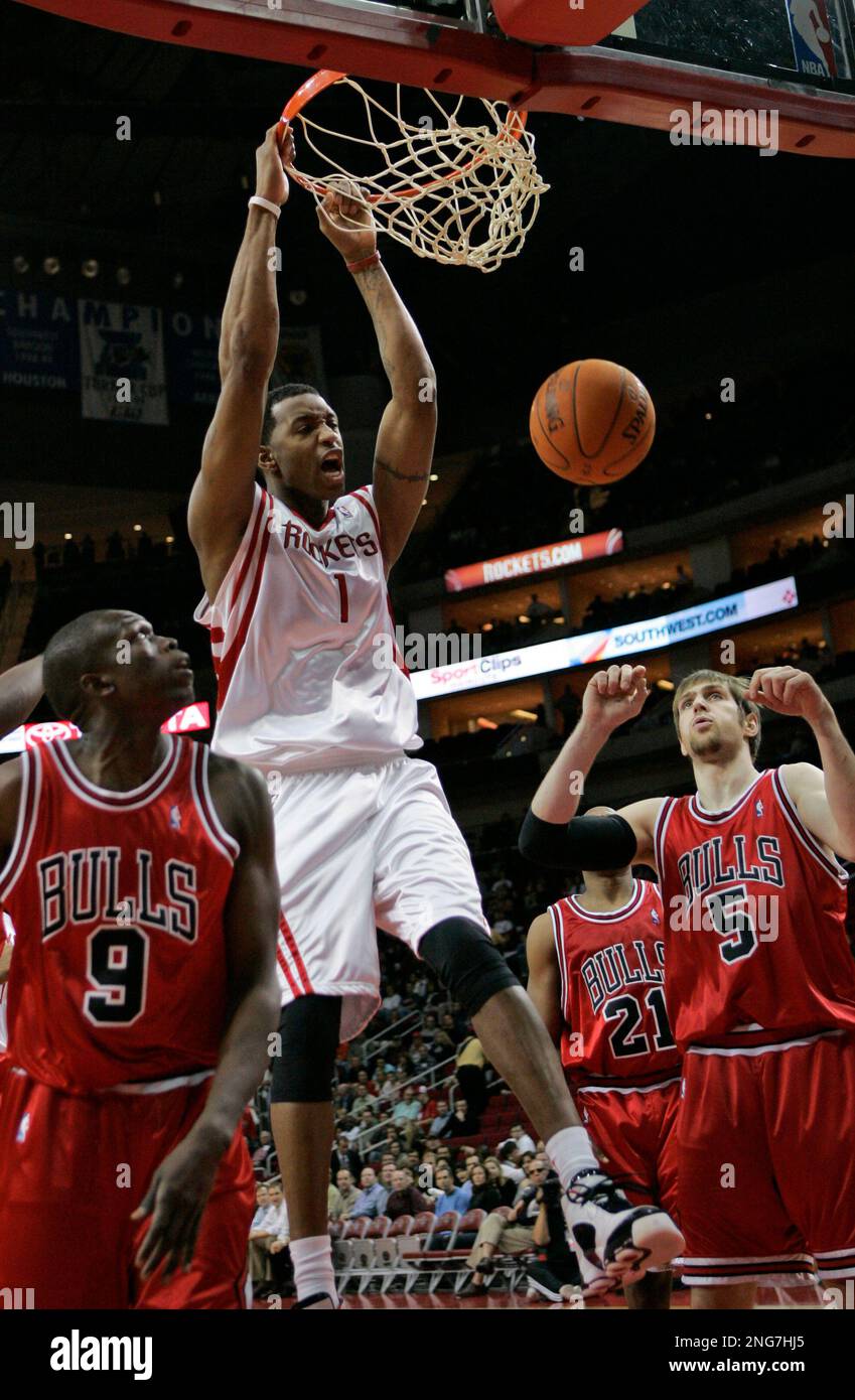 Houston Rockets' Tracy McGrady (1) dunks the ball as Chicago Bulls' Luol  Deng (9), of Sudan, and Chicago Bulls' Andres Nocioni (5), of Argentina,  watch during the first quarter of their NBA