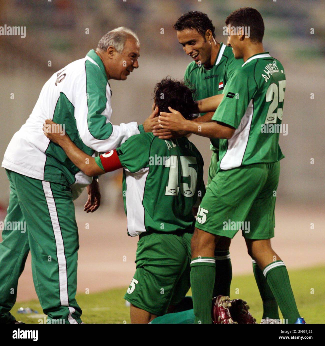 Iraqi Players celebrate their victory with their coach Yahya