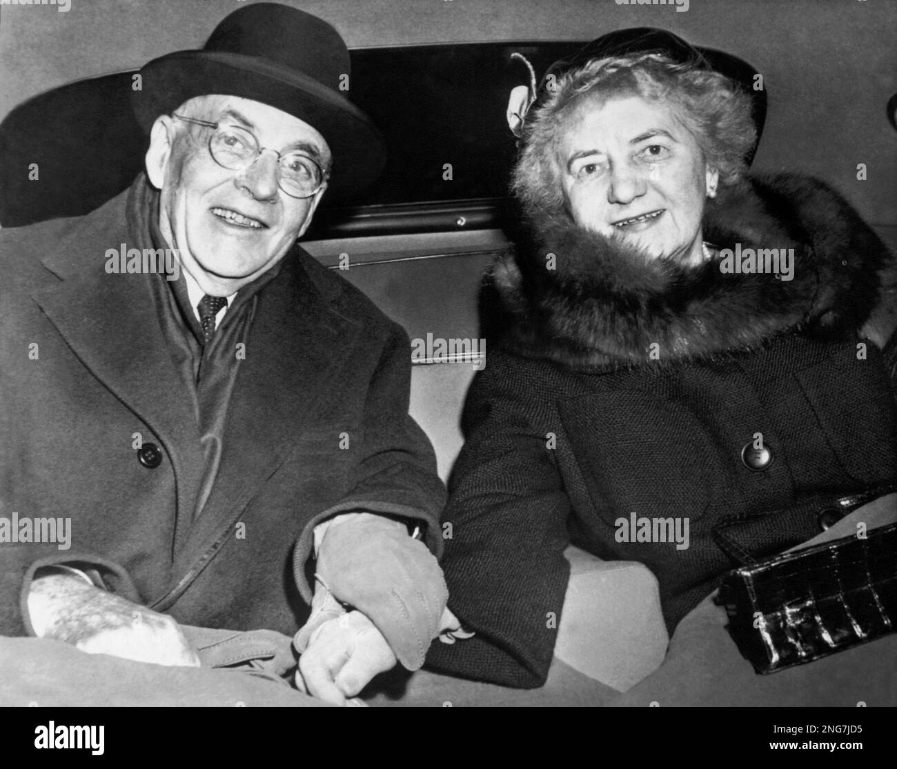 U.S. Secretary of State John Foster Dulles sits in the back of a car
