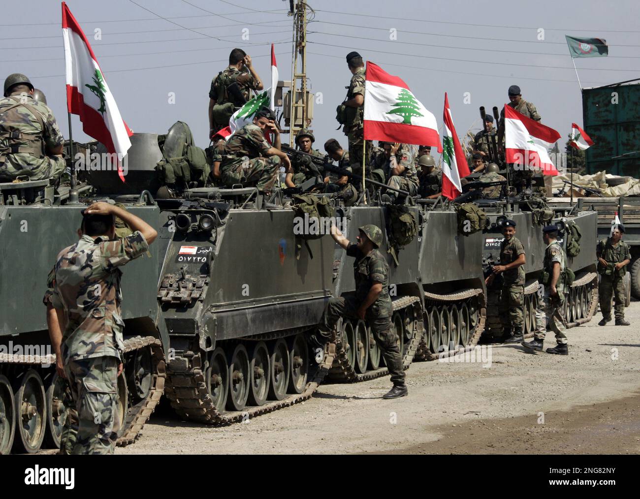 Lebanese soldiers sit on top M113 armoured personnel carriers as they
