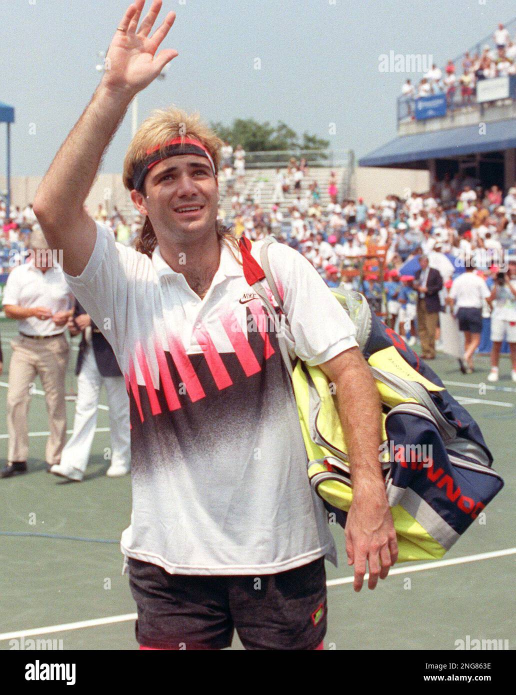 Andre Agassi, of Las Vegas, waves to the crowd as he walks off the ...