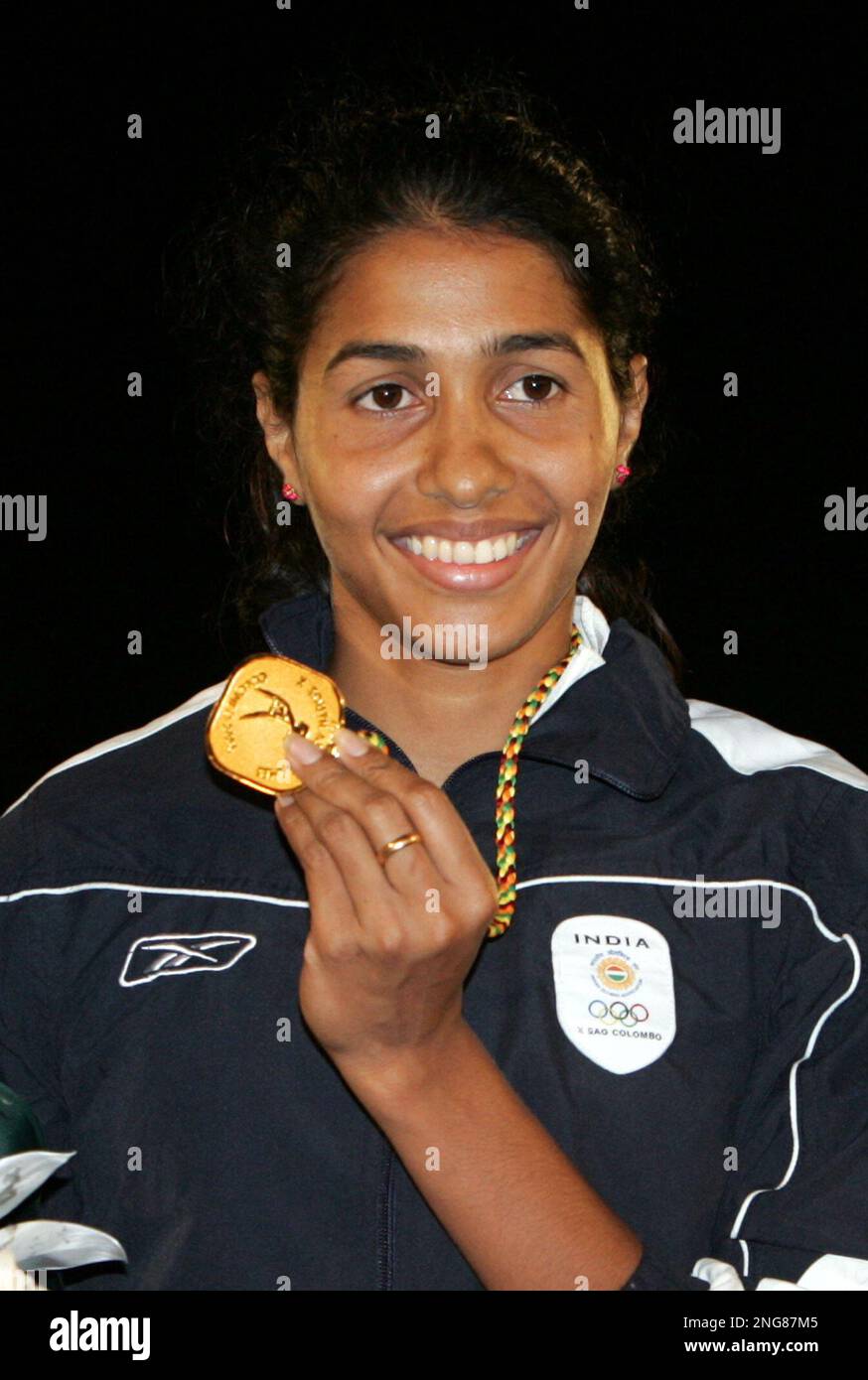 India's Anju Bobby George poses with her gold medal after the medals ...