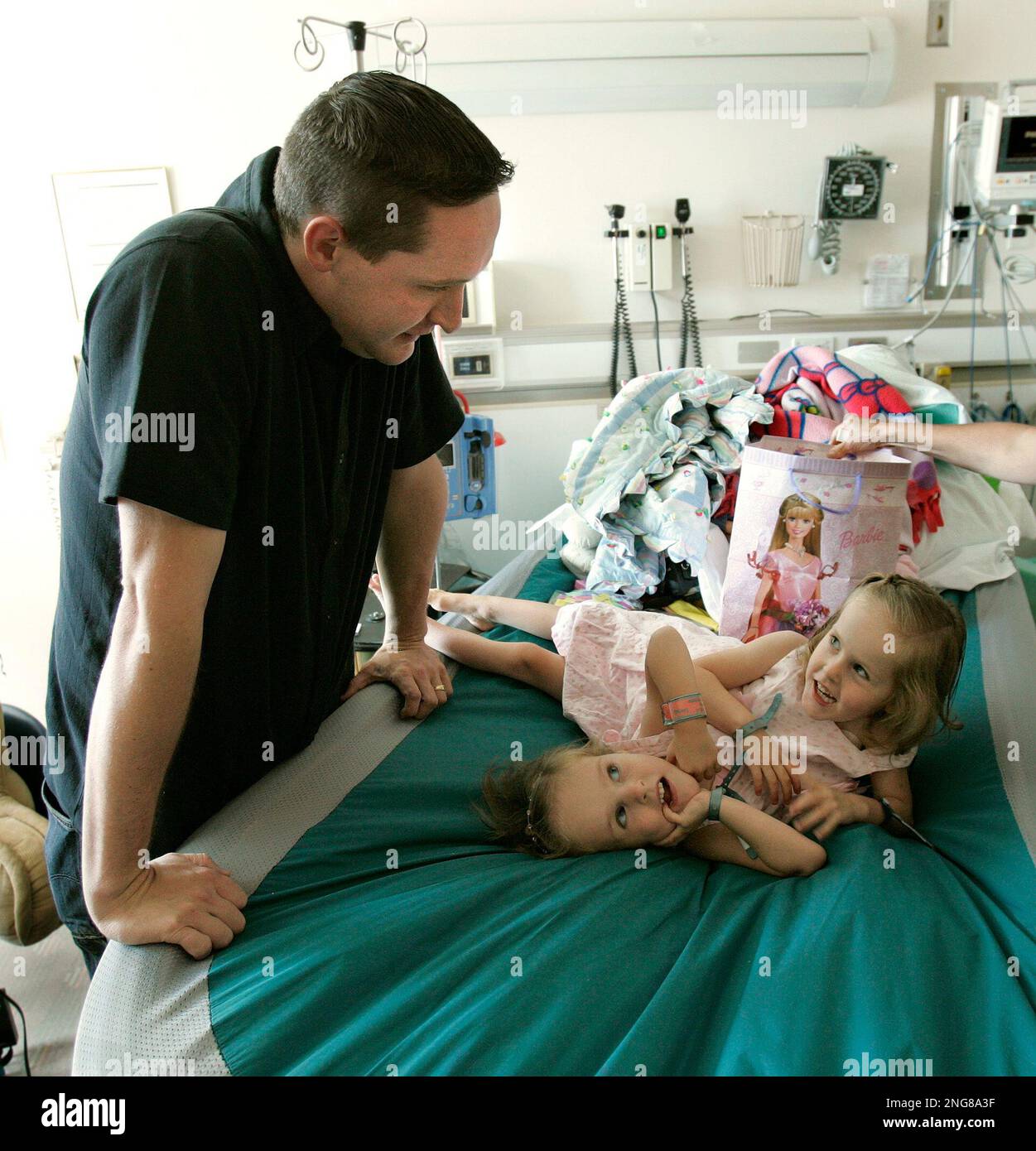 Jake Herrin talks with his conjoined twins Kendra and Maliyah in their  hospital room Thursday, July 13, 2006, at Primary Children's Medical Center  in Salt Lake City. Both girls are big on